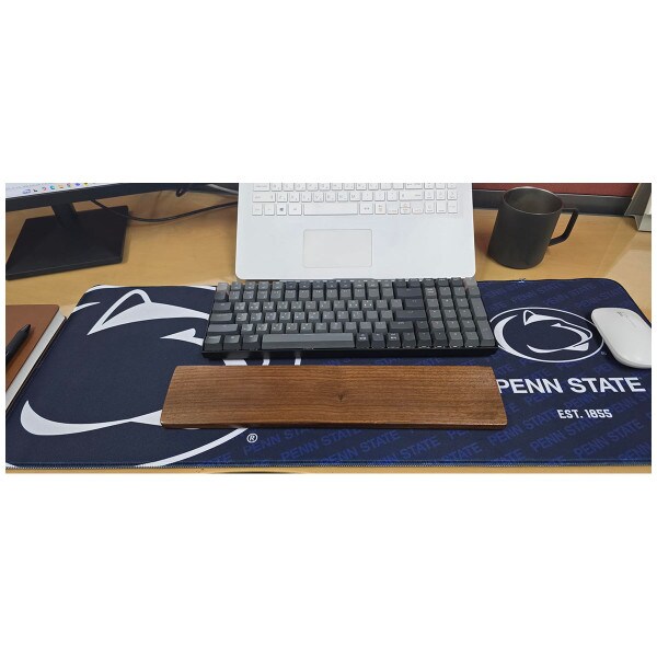 Penn State desk pad on desk with keyboard, computer, and mouse